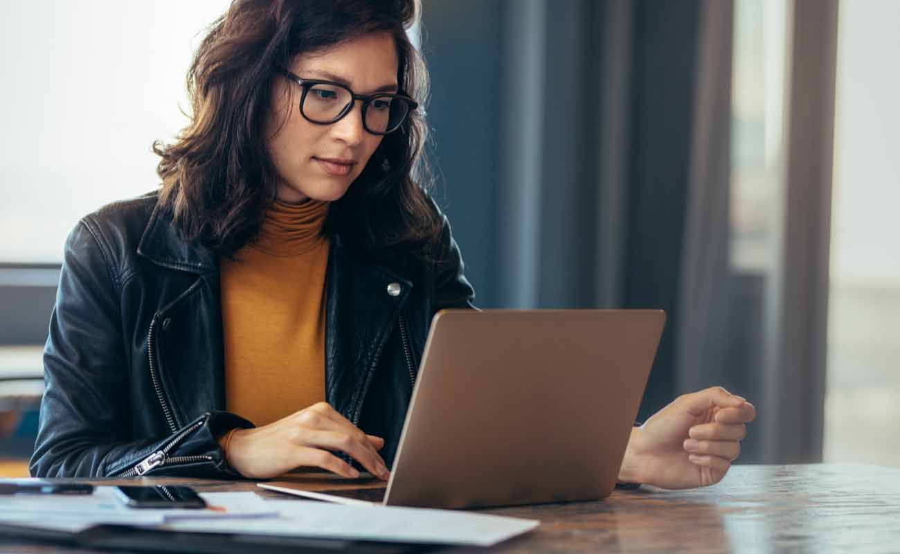 A woman working on her laptop. A woman working on her laptop.