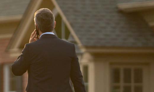 A realtor walking away from a home.