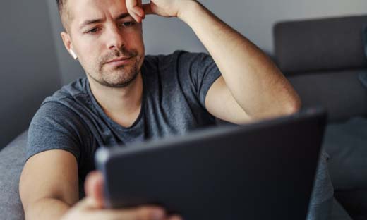 Man looking down at a tablet
